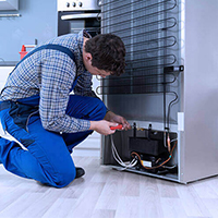 Technician repairing washing machine
